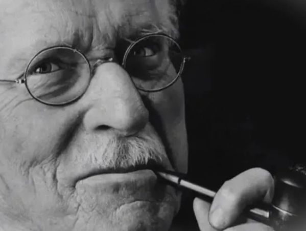 Carl Jung, the founder of Analytical Psychology, deep in thought, smoking his pipe.