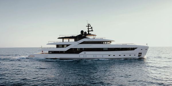 Luxurious modern yacht sailing on calm ocean waters.