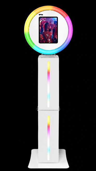 Photo booth with colorful ring light and digital display.