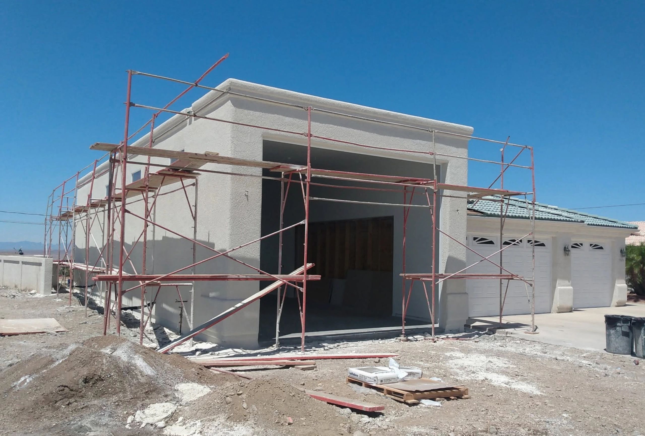 A house under construction with scaffolding around it.