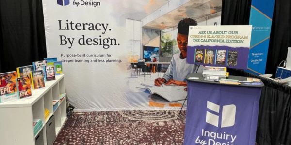 Inquiry by Design trade show booth with the new Literacy. By design. backdrop and redesigned books o