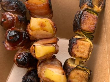 Bacon-wrapped apples and dates, seasoned with fresh thyme and ginger.