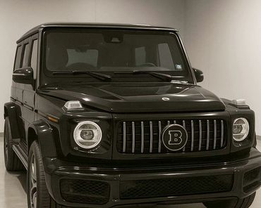 Black luxury SUV with distinctive front grille and circular headlights.