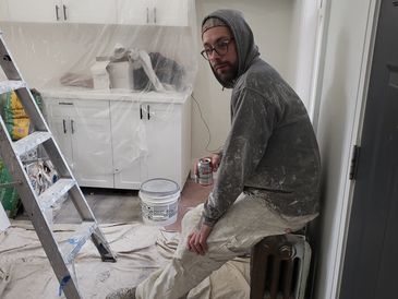 Worker painting the house