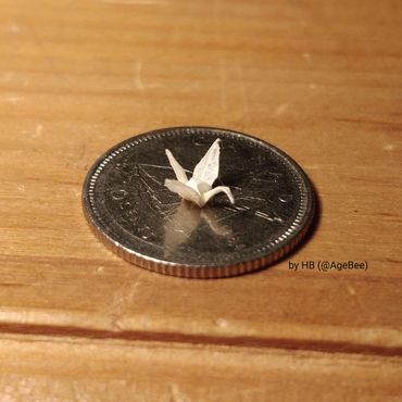 Tiny traditional origami Crane on a ½ dollar coin