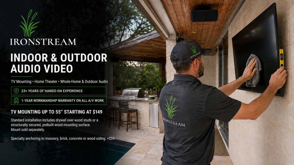 Technician mounts and cleans TV for IRONSTREAM indoor and outdoor audio video services.