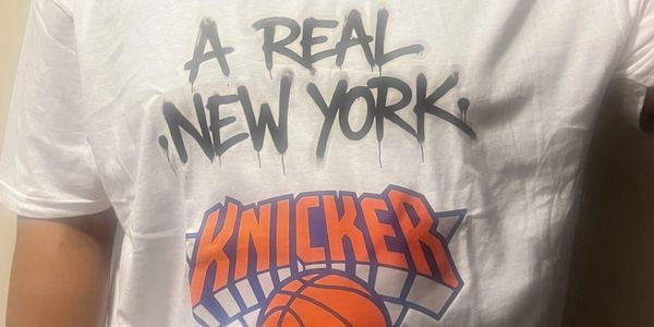 White t-shirt with 'A Real New York Knickerbocker' and basketball logo design.