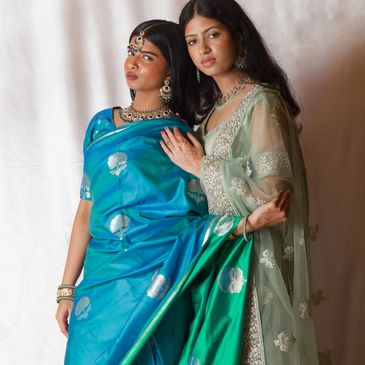 Modern Indian women wearing blue saree sari, green lehenga choli dress of India, fancy jewelry tikka
