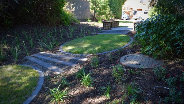 Feature lawn and seating area with complimentory planting in a unit complex