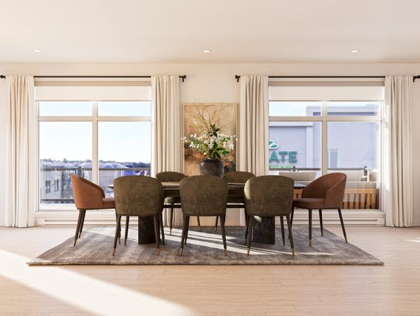 Elegant dining area with a wooden table, cushioned chairs, and floral centerpiece.