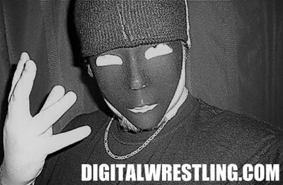 Person wearing a dark mask and beanie, making a hand gesture.