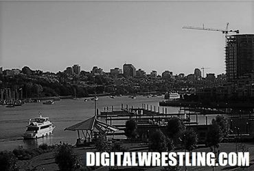 Black and white cityscape with a river and boat.