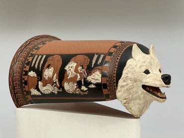 Red-figure and sculpted white ground thigh guard. Salish Wool dog.