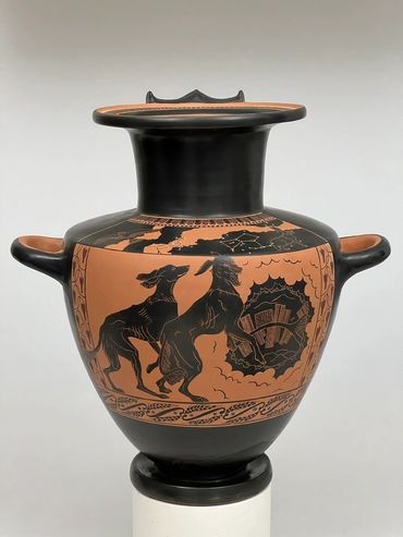 Front view of hydria showing two Salukis playing in the clouds. Black-figure water jug.
