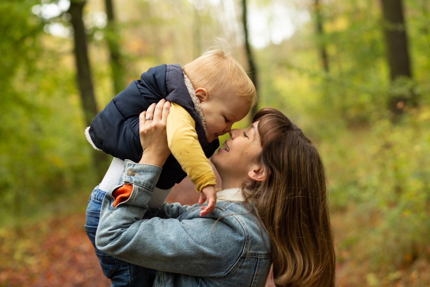 Freelance writer and teacher Lauren Dixon is lifting up her son, and touching nose-to-nose.