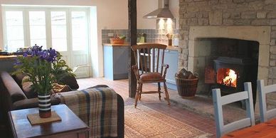 Open plan living and dining area including wood burning stove