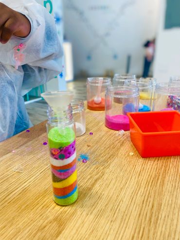 Kids experimenting with fun science and sand art during open labs