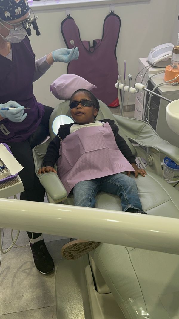 Happy child during dental checkup at Sorriso Dental Care in a friendly setting