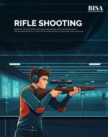 A focused young man practicing rifle shooting at an indoor range.