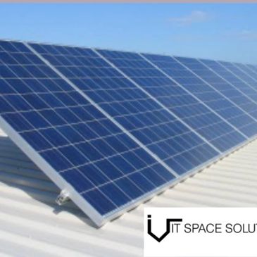 Solar panels installed on a rooftop under clear blue sky.