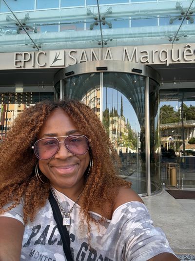 Woman smiling outside Epic Sana Marquês hotel.