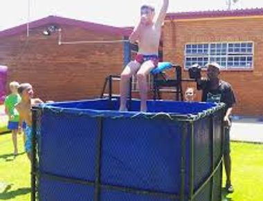 Dunk tank - game to dunk a person in water from a seat above the water