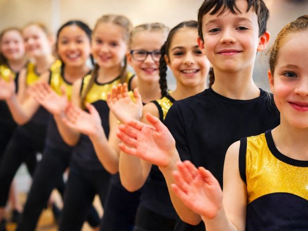 Group of smiling children in a line.