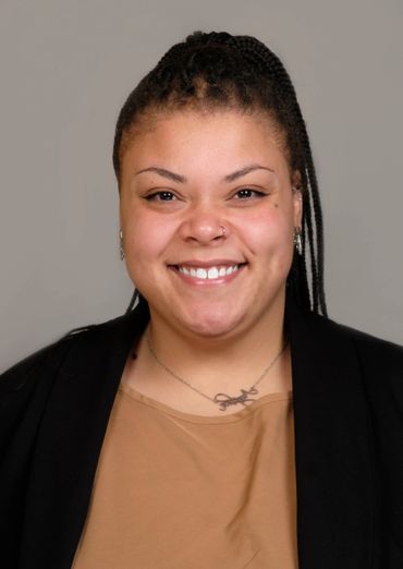 lightskin woman braid hair big smile studio portrait