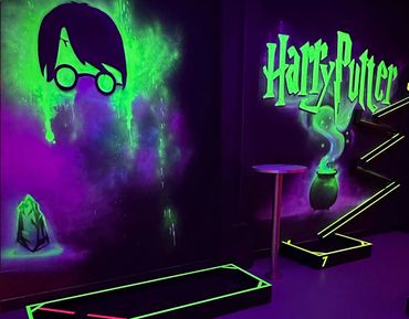 Glowing Harry Potter-themed wall art with neon green and purple hues.