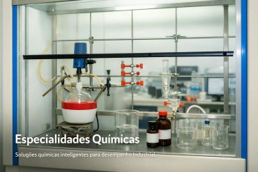 Laboratory glassware and chemicals set up for industrial chemical research.