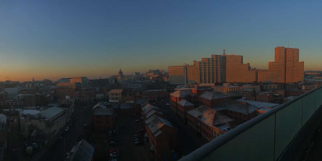 City skyline bathed in warm sunset light.