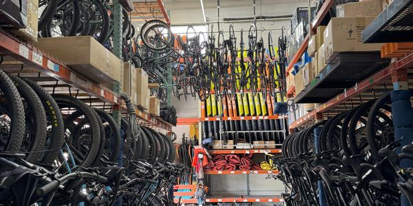 Cliff Creek Outfitters Warehouse full of neatly organized cyclingequipment- road bikes, mtb