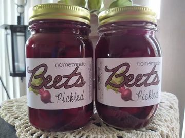 Two jars of pickled beets with handwritten labels.