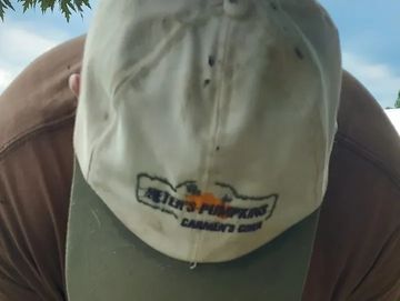 Man wearing a hat with the PP&CC logo.