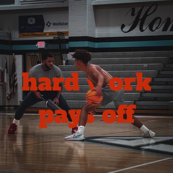 Two men playing basketball in a gym with the text 'hard work pays off'.