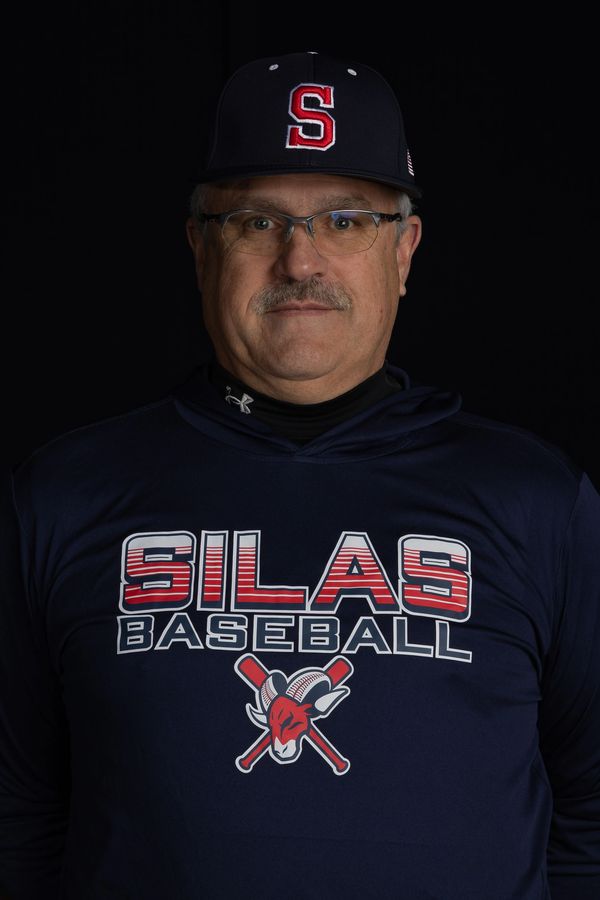 Man wearing Silas Baseball shirt and cap against a black background.
