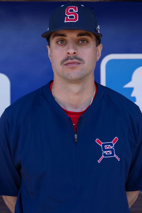 Baseball player in blue uniform and cap with an 'S' logo.