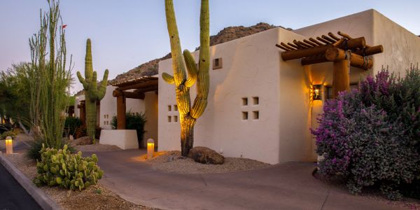Single family home for sale with cacti lining the sidewalk