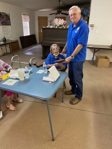 Bill Thedford presenting Frederica Wyatt with a plaque for 22 years service as she retires from her