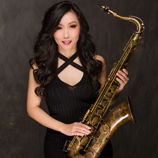 Long hair asian saxophone player with tenor sax