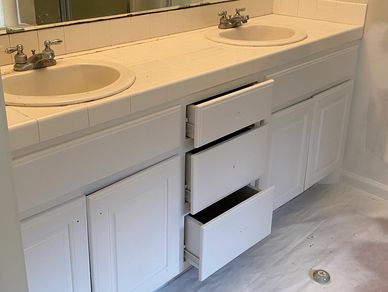 Progress image of bathroom vanity being painted