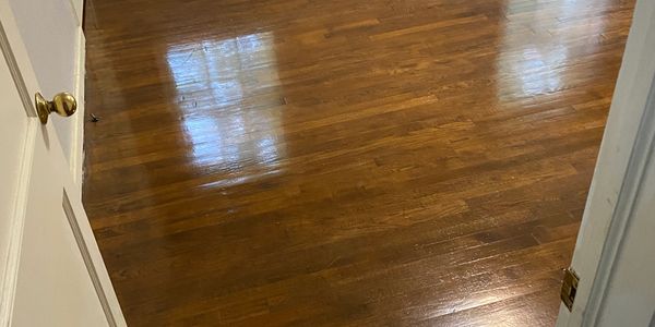 Close up of glossy refinished hardwood flooring in a rehab property.