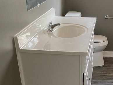 Updated bathroom with new sink pedestal, new tub and shower surround, flooring, toilet, and paint
