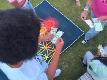 showing young people holding money