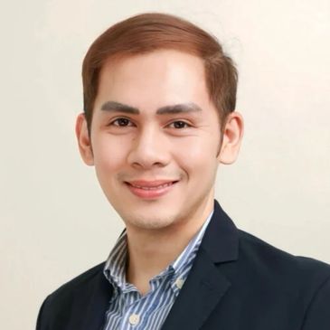 Smiling man in business attire with neatly combed hair.