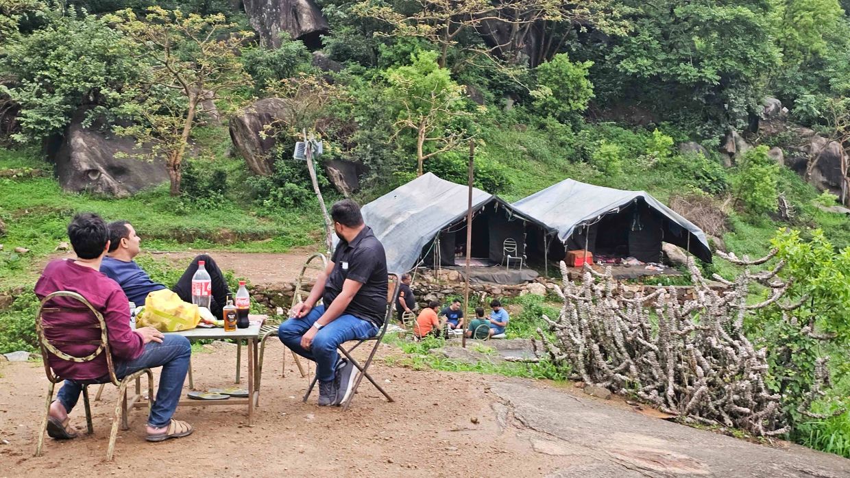 guest sitting at campsite