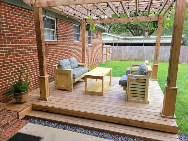 wooden pergola on a wooden deck and wooden furniture