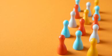 A picture of game pieces of different colors, grouped together in an organized fashion.