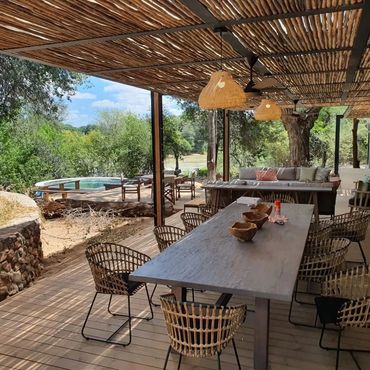 Outdoor dining area with rustic decor and natural surroundings.