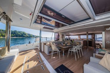 Luxurious yacht interior with dining area and ocean view.